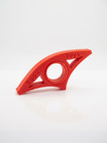 The Page Keeper thumb page holder in red, holding a book open with one hand